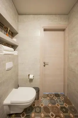 a bathroom with a toilet and a door at Vincent Heritage Appartments - Near Clinic, Arena and Stadium in Kaunas