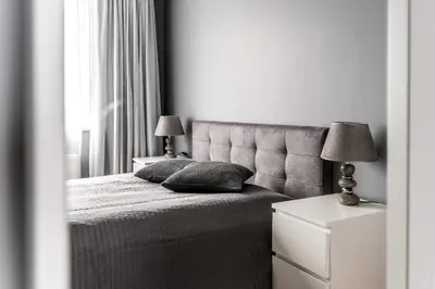 a bedroom with a bed with two lamps and a window at City center apartment, free parking, 149 in Vilnius