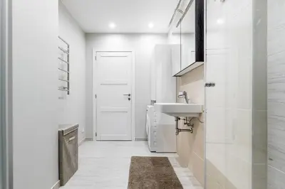 a white bathroom with a sink and a toilet at City center apartment, free parking, 149 in Vilnius