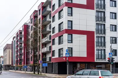 a red and white building on a city street at City center apartment, free parking, 149 in Vilnius