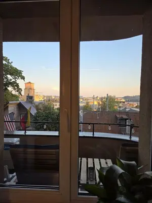 a window with a view of a city outside at Panoramic balcony 3BD apt with king bed in Kaunas