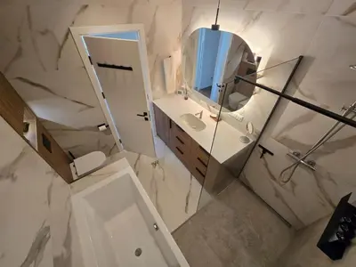 a bathroom with a sink and a mirror at Panoramic balcony 3BD apt with king bed in Kaunas