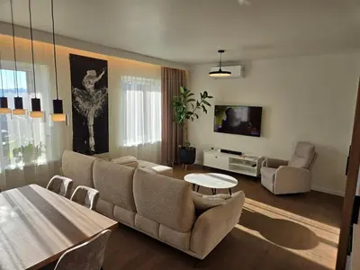 a living room with a couch and a tv at Panoramic balcony 3BD apt with king bed in Kaunas