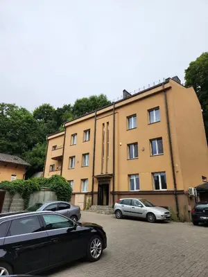 a black car parked in front of a building at Panoramic balcony 3BD apt with king bed in Kaunas