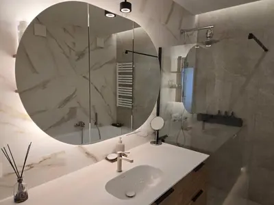 a bathroom with a sink and a mirror at Panoramic balcony 3BD apt with king bed in Kaunas