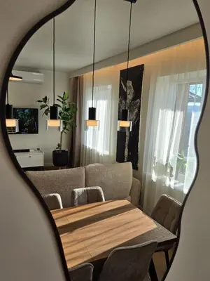a dining room with a table and a couch at Panoramic balcony 3BD apt with king bed in Kaunas