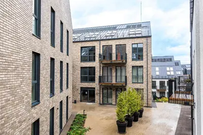 an apartment building with a courtyard with potted plants at City center studio, 24 in Vilnius