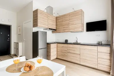 a kitchen with a table and two glasses of wine at City center studio, 24 in Vilnius