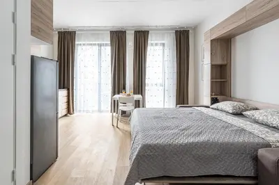 a bedroom with a large bed and a table at City center studio, 24 in Vilnius
