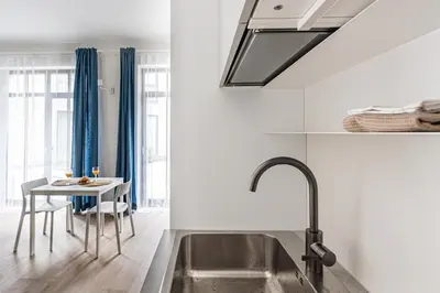 a kitchen with a sink and a table at City center studio, parking, 16 in Vilnius