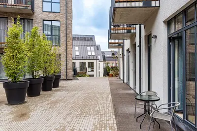 an empty alley with potted plants and a table and chairs at City center studio, parking, 16 in Vilnius
