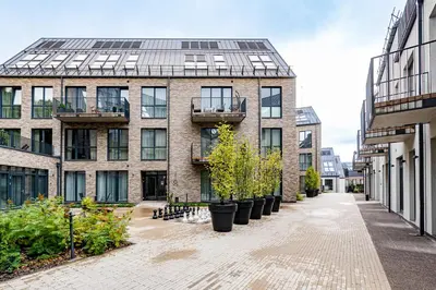 an empty street in front of a building with plants at City center studio, parking, 16 in Vilnius