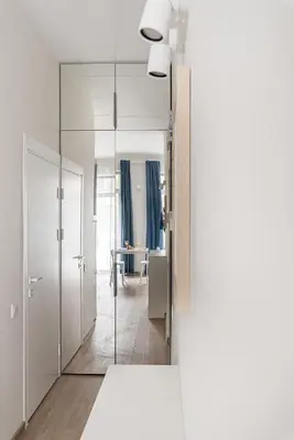 a hallway with a mirror and a table in a room at City center studio, parking, 16 in Vilnius