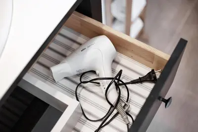 a hair dryer and a hair dryer sitting on a shelf at Spacious Cozy Studio, 3A in Vilnius