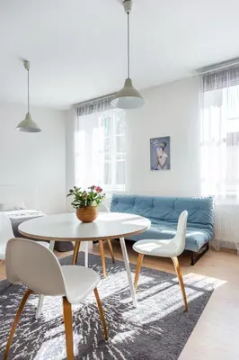 a living room with a table and a couch at Spacious Cozy Studio, 3A in Vilnius