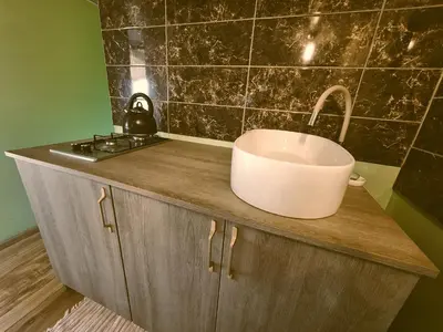 a sink on top of a counter in a bathroom at Miško Pašvaistėje - poilsis gamtoje in Balneliškiai