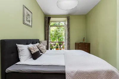 a bedroom with a large bed and a window at City Center apartment, 8 in Vilnius