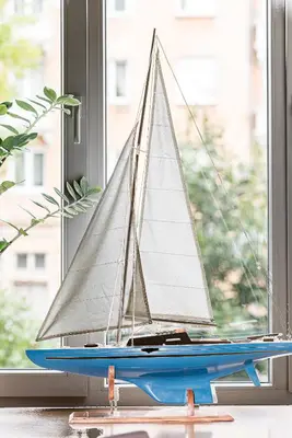 a toy sailboat sitting on a window sill at City Center apartment, 8 in Vilnius