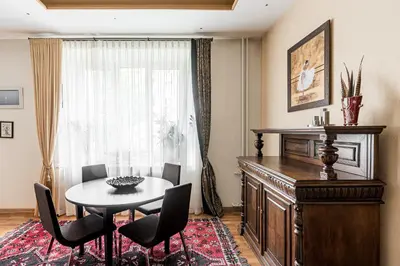 a dining room with a table and chairs and a window at City Center apartment, 8 in Vilnius