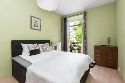 a bedroom with a large bed and a window at City Center apartment, 8 in Vilnius