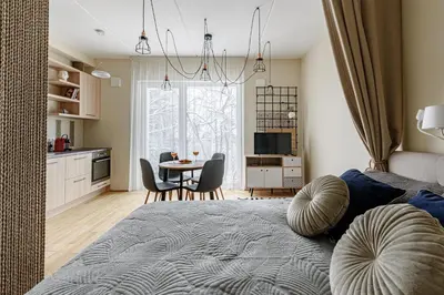 a bedroom with a bed and a table with chairs at City center, studio, 514 in Vilnius