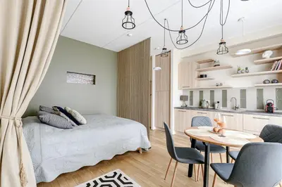 a bedroom with a bed and a table and chairs at City center, studio, 514 in Vilnius