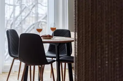 a table with two glasses of wine and two chairs at City center, studio, 514 in Vilnius
