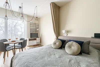 a bedroom with a bed with pillows and a table at City center, studio, 514 in Vilnius