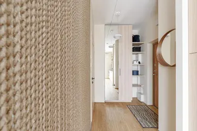 a hallway with a wall covered in textured plaster at City center, studio, 514 in Vilnius