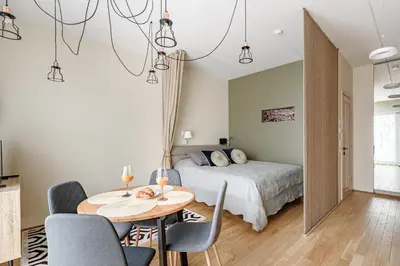 a bedroom with a bed and a table and chairs at City center, studio, 514 in Vilnius