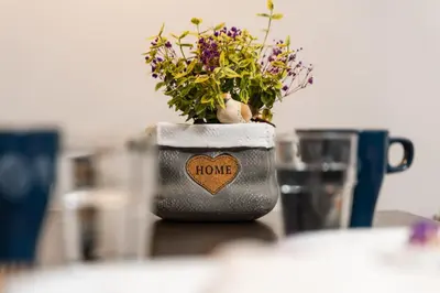 a vase with flowers in it sitting on a table at OZO Park city center in Vilnius