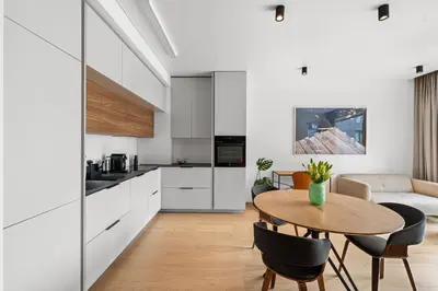 a kitchen and living room with a table and chairs at City center, 91 with parking in Vilnius