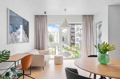 a living room with a table and a large window at City center, 91 with parking in Vilnius
