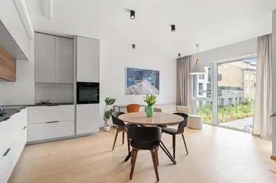 a kitchen and dining room with a table and chairs at City center, 91 with parking in Vilnius