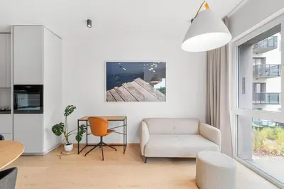 a living room with a chair and a table at City center, 91 with parking in Vilnius