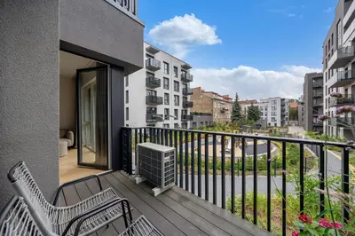 an apartment balcony with two chairs and a balcony at City center, 91 with parking in Vilnius