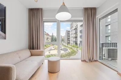 a living room with a couch and a large window at City center, 91 with parking in Vilnius