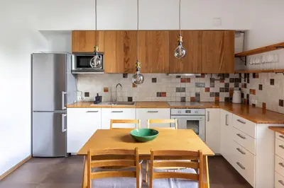 a kitchen with a wooden table with a green bowl on it at Cosy Loft with Terrace in Paupys by URBAN RENT in Vilnius
