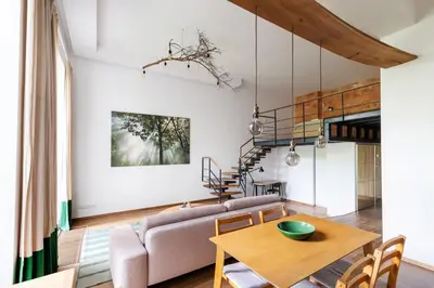 a living room with a couch and a table at Cosy Loft with Terrace in Paupys by URBAN RENT in Vilnius