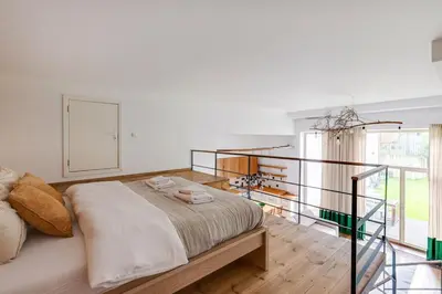 a bedroom with a large bed and a large window at Cosy Loft with Terrace in Paupys by URBAN RENT in Vilnius