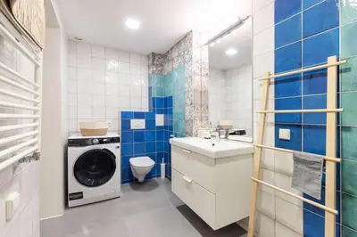 a bathroom with a washing machine and a washer at Cosy Loft with Terrace in Paupys by URBAN RENT in Vilnius