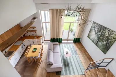 a living room with a couch and a table at Cosy Loft with Terrace in Paupys by URBAN RENT in Vilnius