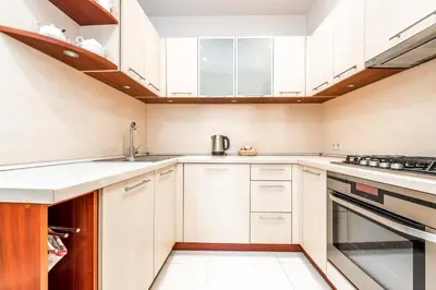 a kitchen with white cabinets and white appliances at Angel House Vilnius, 32 in Vilnius