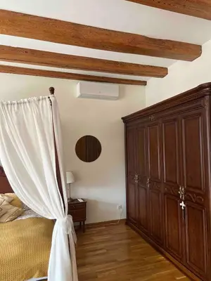 a bedroom with a bed and a wooden cabinet at Angel House Vilnius, 32 in Vilnius
