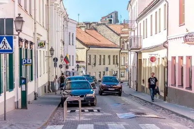 a city street with cars parked on the street at Angel House Vilnius, 32 in Vilnius