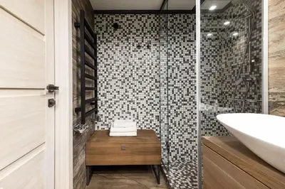 a bathroom with a sink and a glass shower at Old Brewery Loft in Paupys by Urban Rent in Vilnius