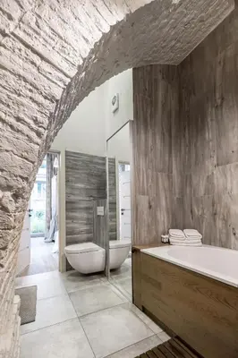 a bathroom with two toilets and a bath tub at Old Brewery Loft in Paupys by Urban Rent in Vilnius