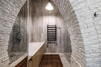 a bathroom with a shower and a sink and a ladder at Old Brewery Loft in Paupys by Urban Rent in Vilnius