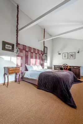 a bedroom with a large bed and a table at City center, free parking, 4A in Vilnius