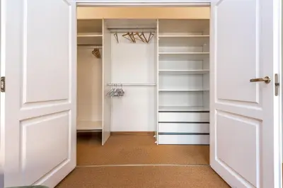 a walk in closet with white doors and shelves at City center, free parking, 4A in Vilnius
